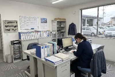 自動車整備工場・販売店の事務所で事務作業をしている様子