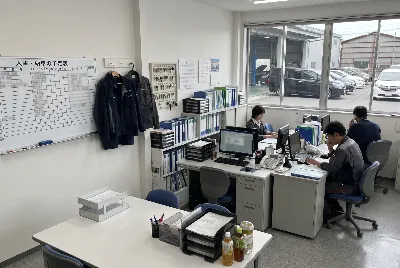 自動車整備工場・販売店の事務所で事務作業をしている様子